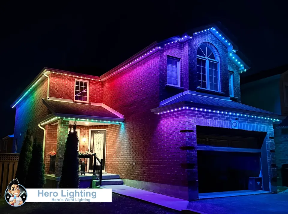 Rainbow colour-changing permanent LED lights outlining a two-storey Kitchener-Waterloo home at night